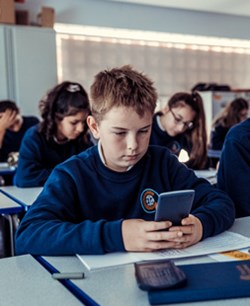 Boy uses calculator at Gosforth Academy